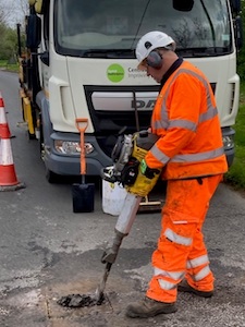 Worker fixing a pothole