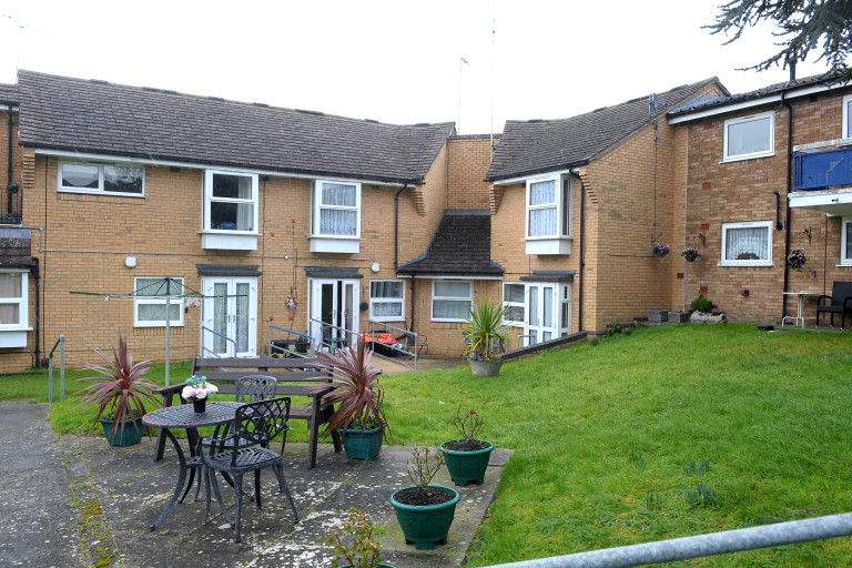 Communal garden with seating area and lawn at Baker Street independent living scheme, Leighton Buzzard.