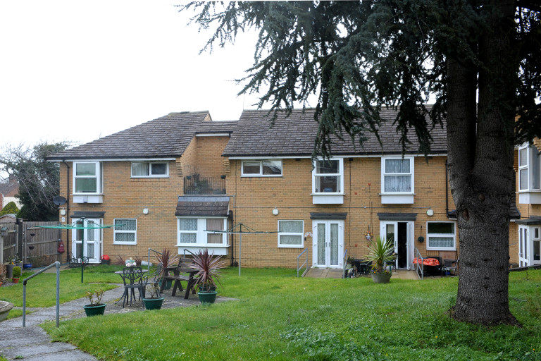 Communal garden with lawn, seating and landscaped planting at Baker Street independent living scheme.