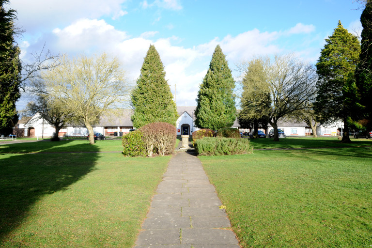 Pathway across Croft Green leading to landscaped communal gardens and housing.