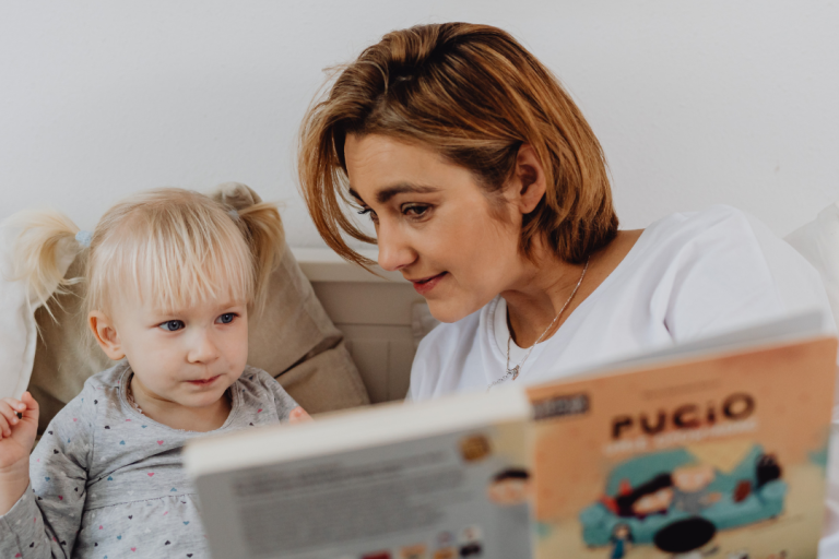 Foster carer reading a book to a child