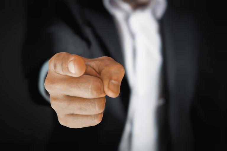 person pointing a finger towards the camera 