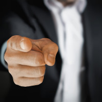 person pointing a finger towards the camera 