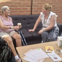 An image of a housing tenant talking to a member of the housing team. 