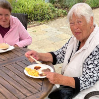 Two local tenants eating lunch together, outside
