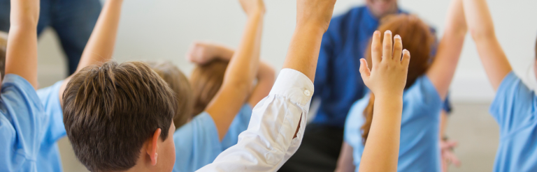Classroom pupils raising hands