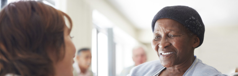 Older lady sitting down with carer