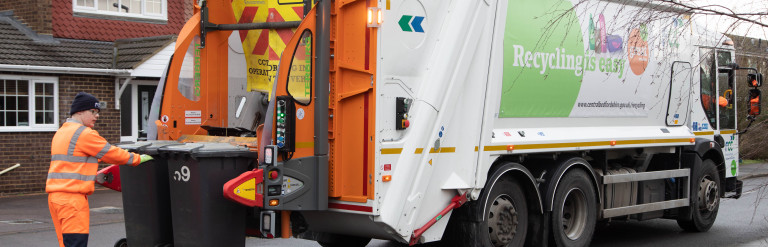Household waste collection lorry on a residential street